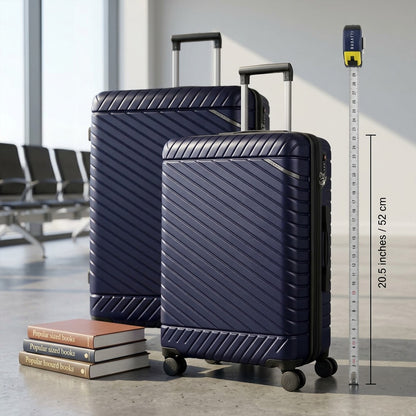 Bugatti Oslo navy carry-on suitcase shown beside books and a tape measure for size reference.