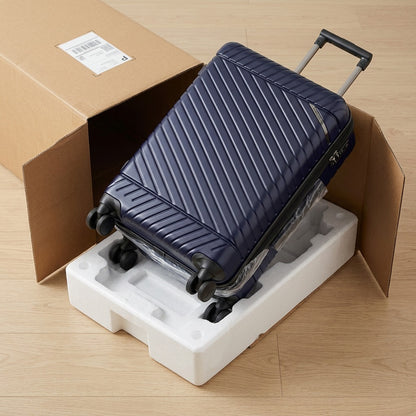 Navy Bugatti Oslo carry-on luggage being unboxed from a secure shipping carton with foam inserts.