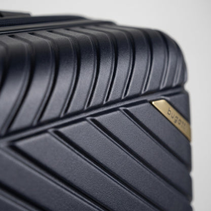 Macro detail of the navy polycarbonate shell on a Bugatti Oslo luggage, showing textured ridges.