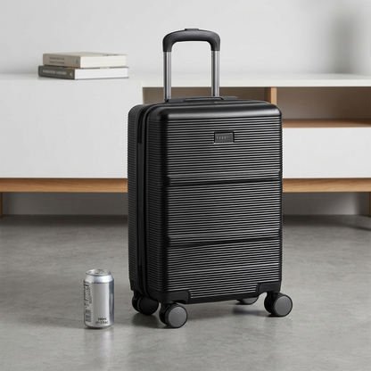 Black Bugatti Brussels hardside carry-on luggage shown next to a soda can for scale reference.