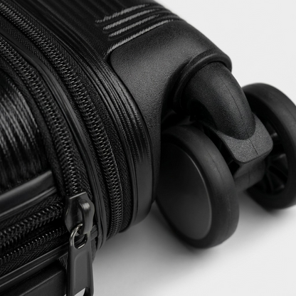 Close-up of Bugatti Brussels hardside luggage showing 360-degree spinner wheels and zipper detail.