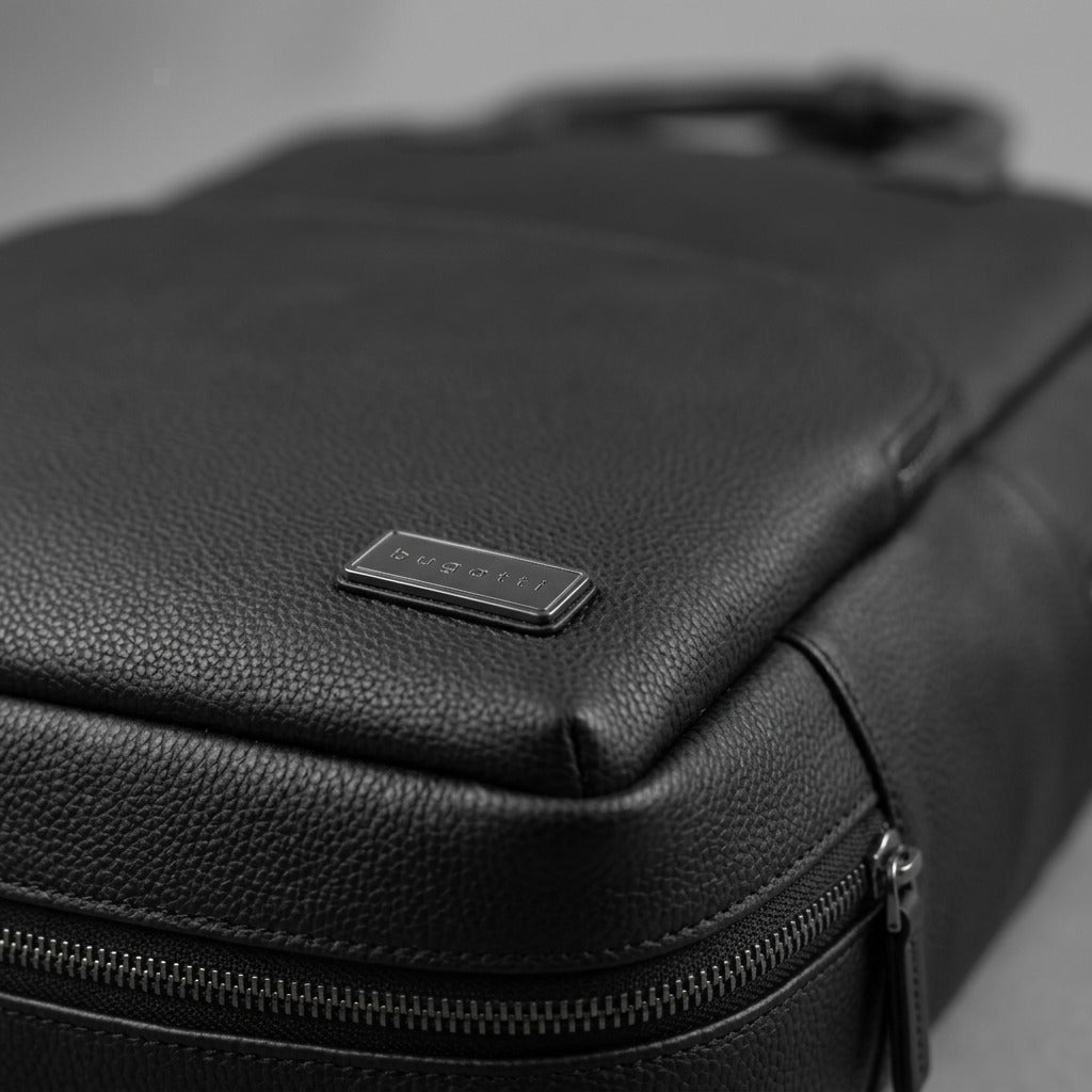 Macro detail of the Bugatti Contrast Backpack showing the pebble grain vegan leather and metal logo.