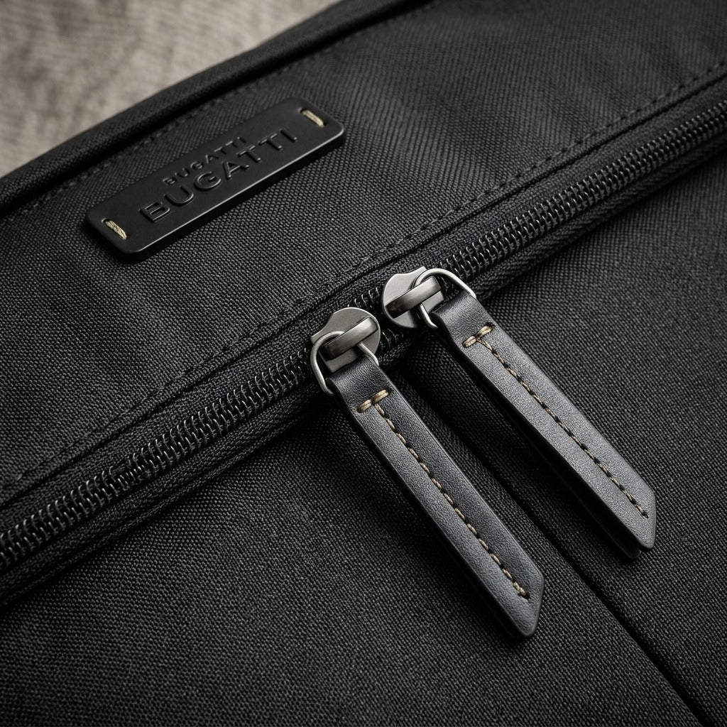 Macro detail of Bugatti Reborn bag showing recycled rPET fabric, dual zippers, and logo patch.