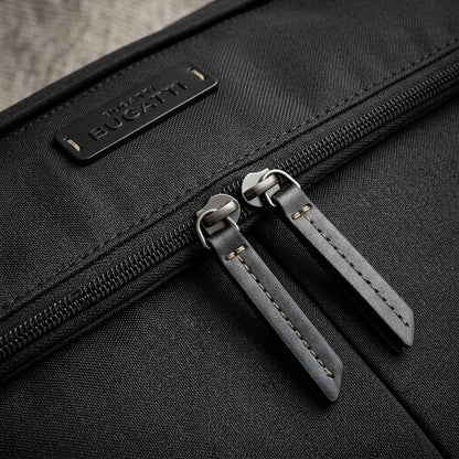 Macro detail of Bugatti Reborn bag showing recycled rPET fabric, dual zippers, and logo patch.
