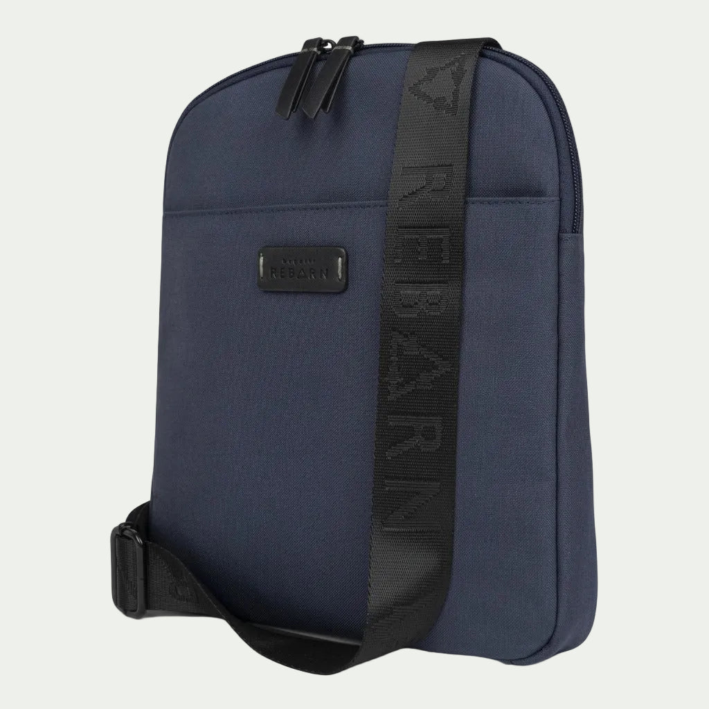 Bugatti Reborn Navy Slim Crossbody Bag made of sustainable material with a branded black strap.