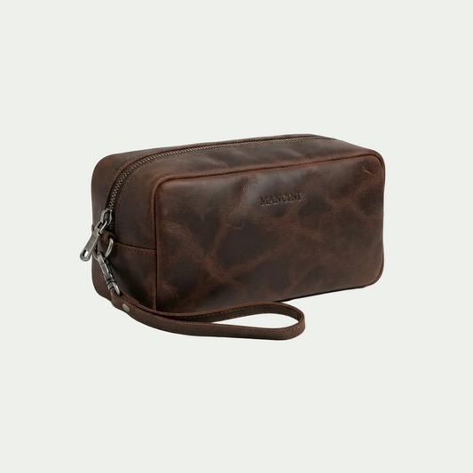 Mancini Buffalo Leather Toiletry Kit in brown with top zipper and wrist strap on white background.
