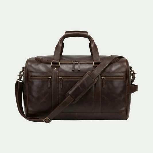 Brown top grain leather Mancini carry-on duffle bag with dual handles and padded shoulder strap.