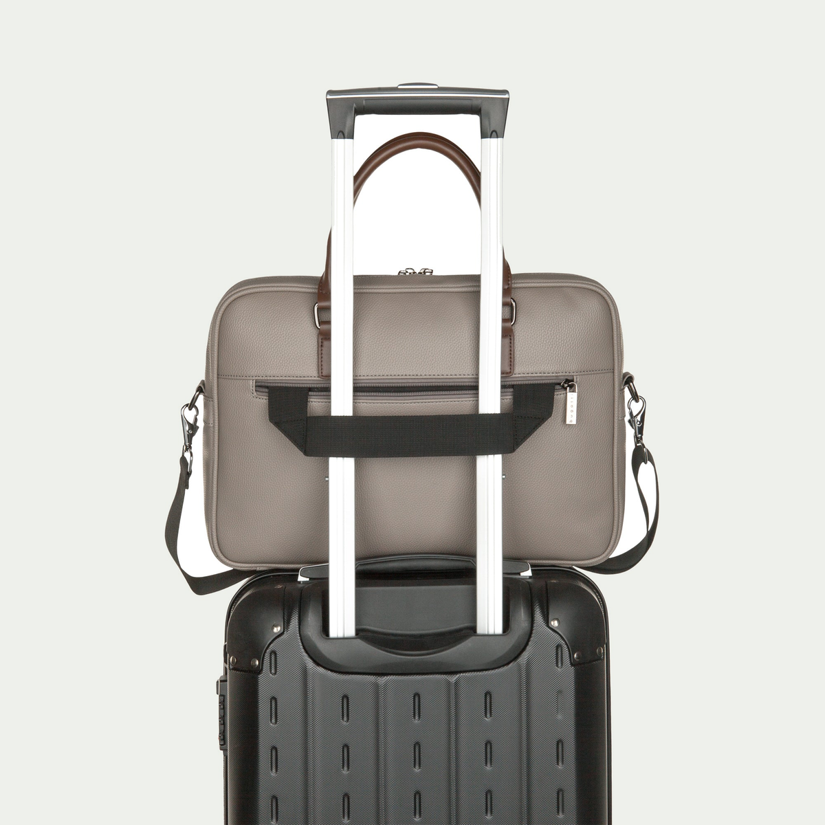 Bugatti Contrast briefcase in grey, secured to a suitcase handle with the rear luggage strap