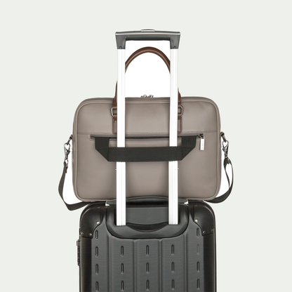 Bugatti Contrast briefcase in grey, secured to a suitcase handle with the rear luggage strap