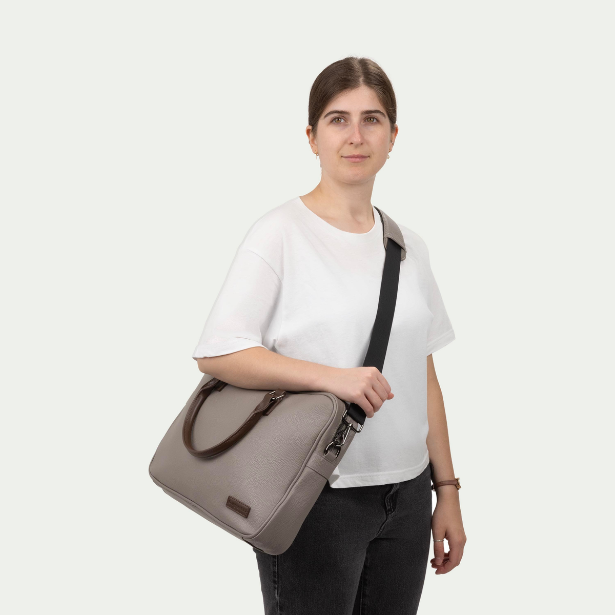 Bugatti Contrast briefcase in grey, worn across the body by a model