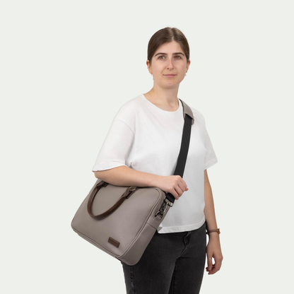 Bugatti Contrast briefcase in grey, worn across the body by a model