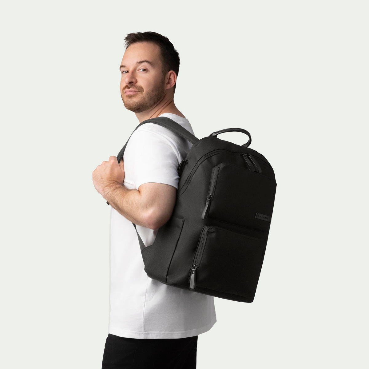 Bugatti Madison backpack in black, worn by a model, side view