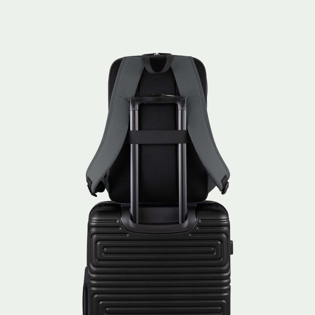 Swiss Mobility Urban Pro Backpack Grey, rear trolley sleeve shown over a suitcase handle