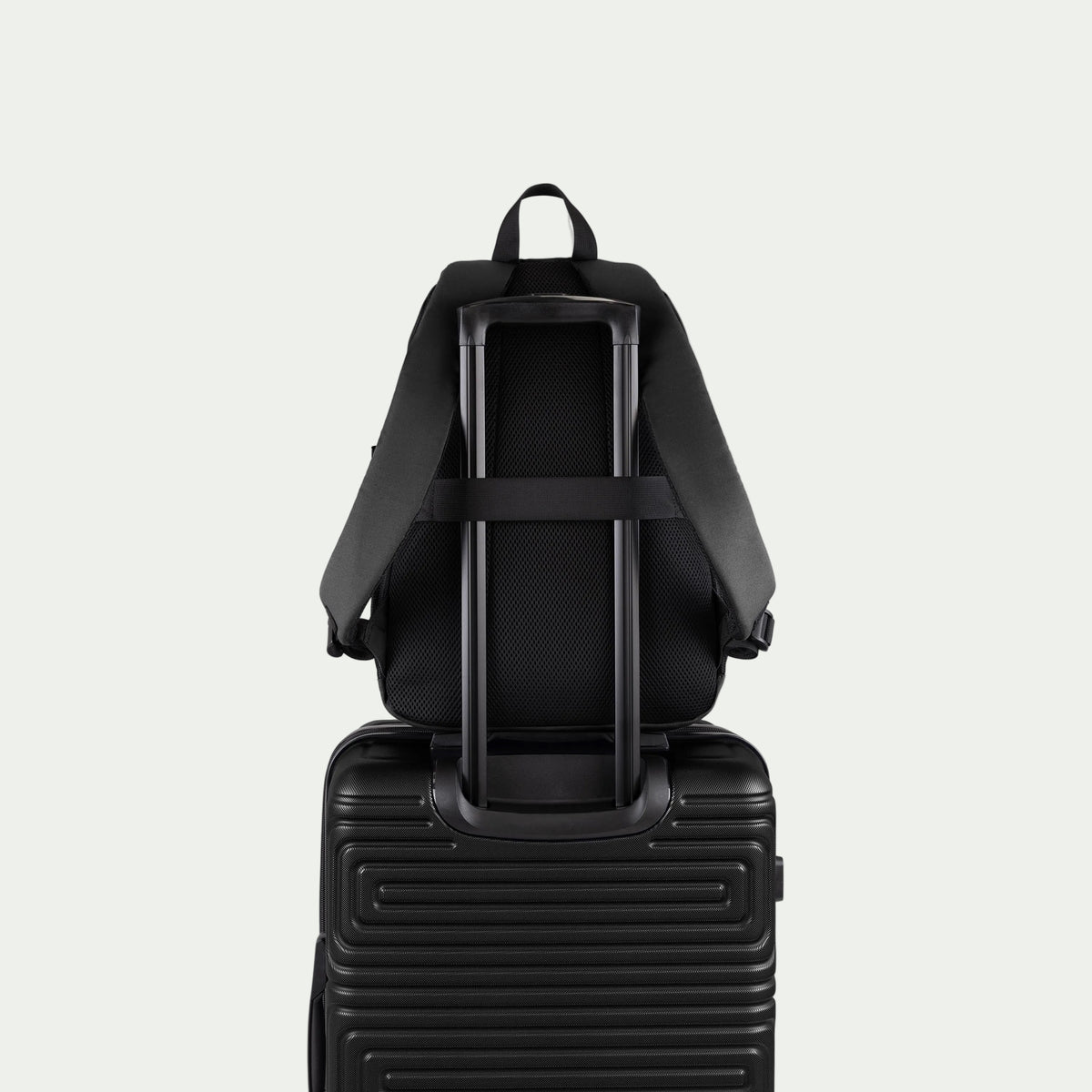 Swiss Mobility Urban Pro Backpack Black, rear trolley sleeve shown over a suitcase handle