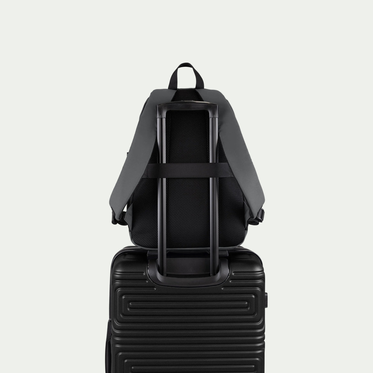 Swiss Mobility Urban Pro Backpack Grey, rear trolley sleeve shown over a suitcase handle