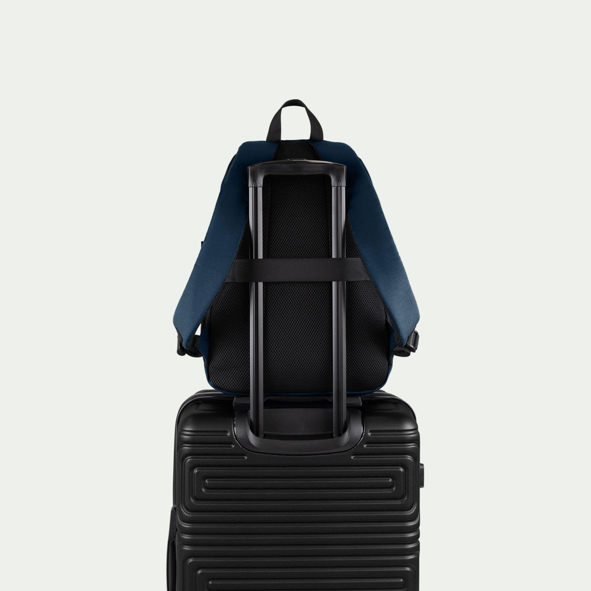 Swiss Mobility Urban Pro Backpack Navy, rear trolley sleeve shown over a suitcase handle