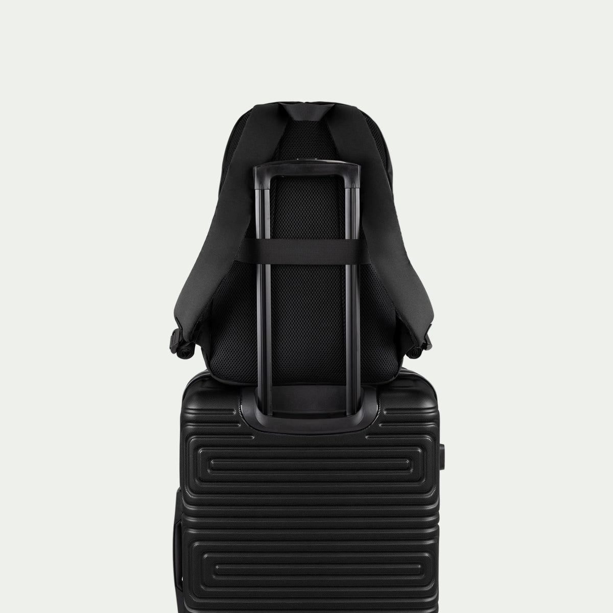 Swiss Mobility Urban Pro Backpack Black, rear trolley sleeve shown over a suitcase handle