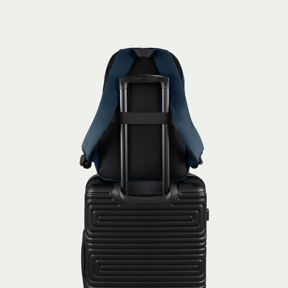 Swiss Mobility Urban Pro Backpack Navy, rear trolley sleeve shown over a suitcase handle
