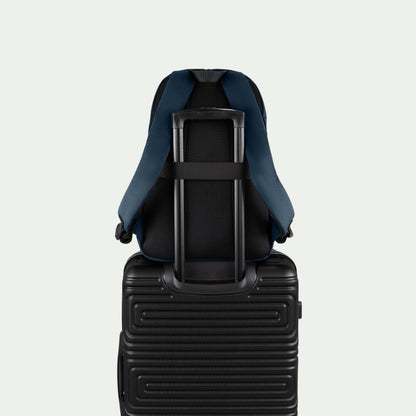 Swiss Mobility Urban Pro Backpack Navy, rear trolley sleeve shown over a suitcase handle