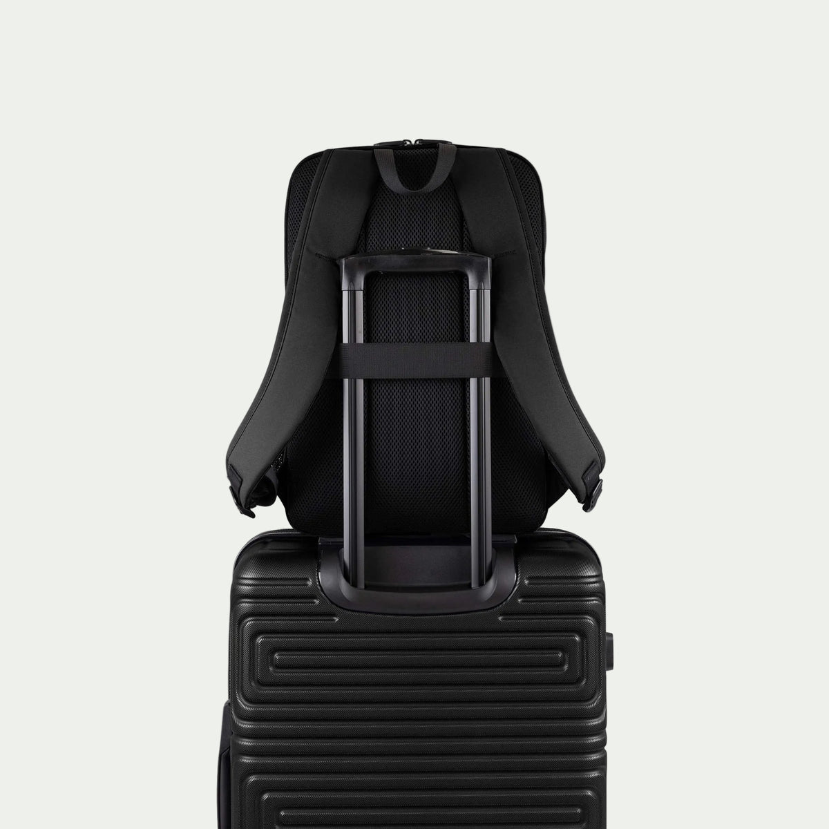 Swiss Mobility Urban Pro Backpack Black, rear trolley sleeve shown over a suitcase handle