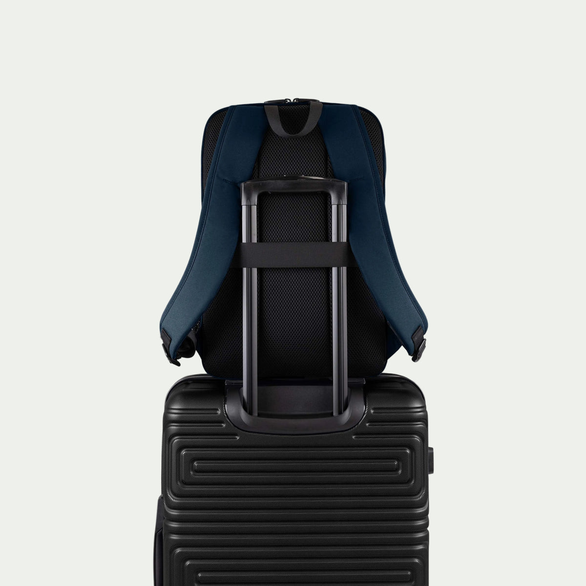 Swiss Mobility Urban Pro Backpack Navy, rear trolley sleeve shown over a suitcase handle