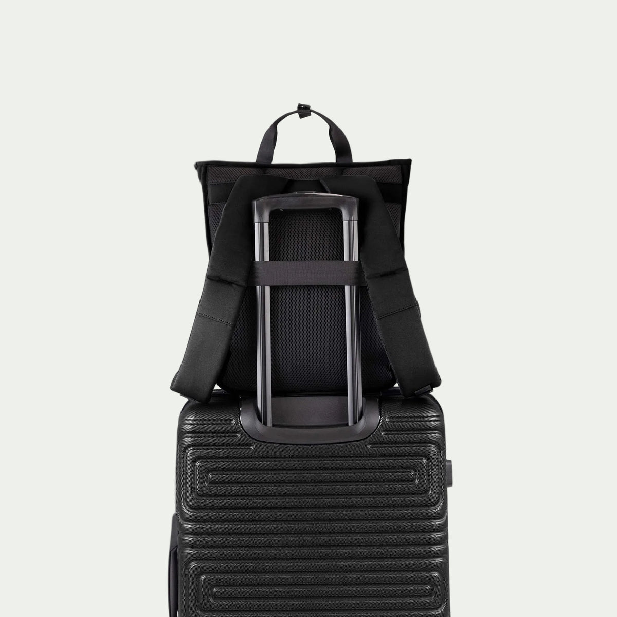 Swiss Mobility Urban Pro Backpack Black, rear trolley sleeve shown over a suitcase handle