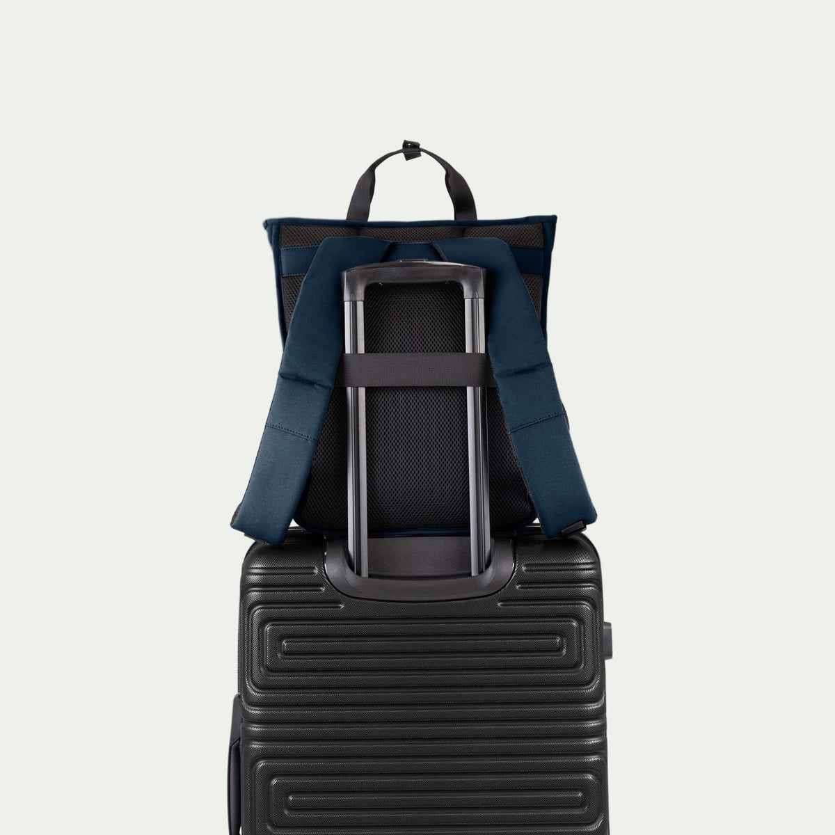 Swiss Mobility Urban Pro Backpack Navy, rear trolley sleeve shown over a suitcase handle