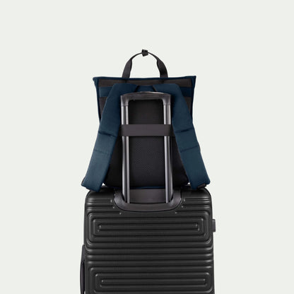 Swiss Mobility Urban Pro Backpack Navy, rear trolley sleeve shown over a suitcase handle